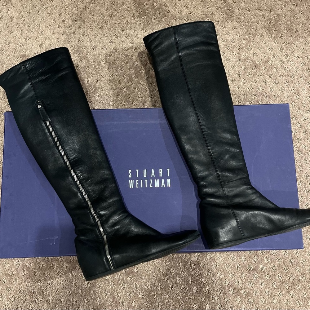Stuart Weitzman “Elf” OTK boots in black leather.